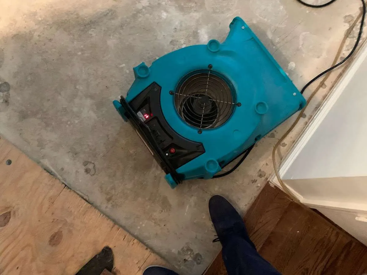 Air mover drying subfloor during Commercial Water Damage Restoration in Beckett Ridge